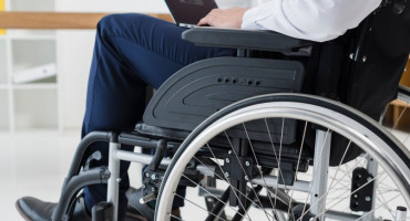 close-up-businessman-sitting-wheelchair-using-laptop-960x640.jpg