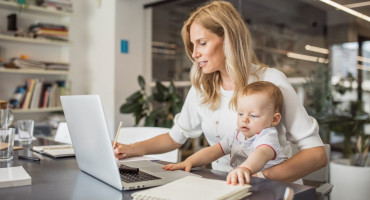 Single-mother-with-baby-working-in-office-1042365540_2131x1410.jpeg