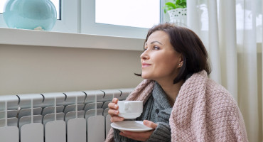 winter-season-woman-warming-up-near-home-heating-2021-12-20-18-31-13-utc.jpg